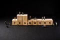 Miniature builders figure with wooden blocks with Ã¢â¬ÅTEAMWORKÃ¢â¬Â wordings